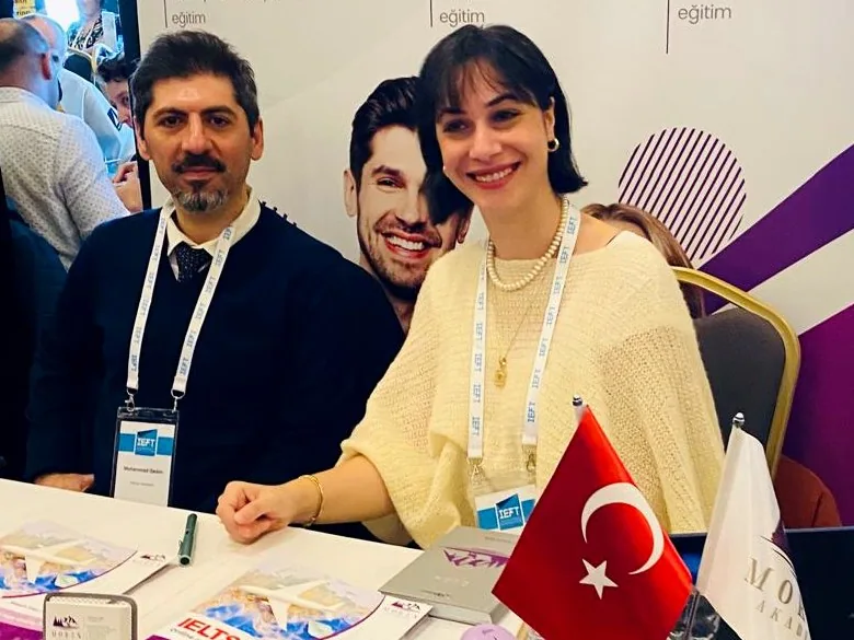 Cemre Işık and Mohammad Qadim at the Moren Akademi stand at an education fair